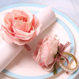 Pink silk rose napkin ring with gold pearl accents and elegant ribbons for table decor