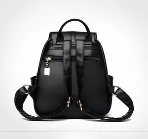 Detail of black pebbled leather backpack showing back anti-theft zipper and gold hardware