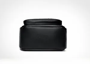 Close-up of black lychee grain leather backpack base with reinforced stitching and logo