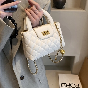 White quilted leather handbag with gold metal ball chain strap and turn-lock closure