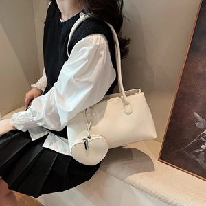 Vintage cream white Boston tote bag with a heart charm and elegant shoulder strap