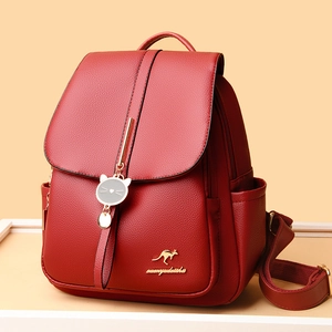 Women's burgundy lychee grain leather backpack with golden kangaroo logo and cat charm