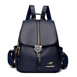 Front view of a navy blue textured leather backpack with gold hardware and cat pendant