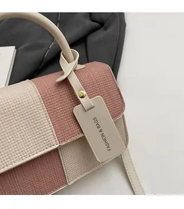 Macro detail of woven pink and beige leather texture on minimalist crossbody bag