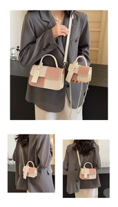 Detail view of large and small color-block flap handbags with woven texture and dual straps