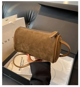 Brown frosted suede Boston cylinder bag shown with elegant gift packaging
