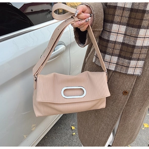 Detail of light beige pleated shoulder bag with silver oval metal hardware and wide strap
