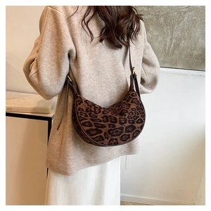 Detail showing high-quality leopard print texture on a half-moon crossbody bag for women