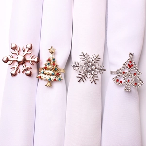 Detail of festive Christmas napkin rings with snowflake and holiday tree designs