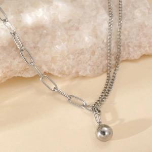 Silver-tone necklace with mixed paperclip and Cuban links featuring a smooth ball pendant