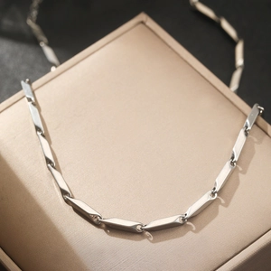Minimalist silver stainless steel geometric link chain necklace on jewelry display