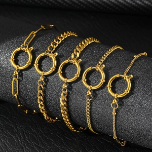 Detail of five assorted 18K gold plated stainless steel bracelets with large spring clasps