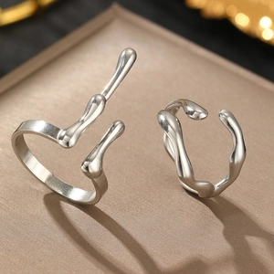 Macro view of liquid metal style silver rings with irregular organic geometric lines