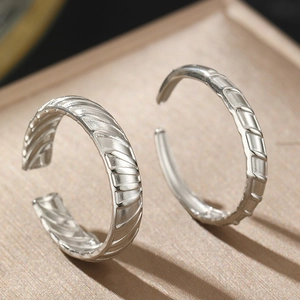 Minimalist silver stainless steel open rings set with geometric textured patterns