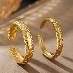 Textured gold-plated open rings with elegant diagonal stripes in a minimalist style
