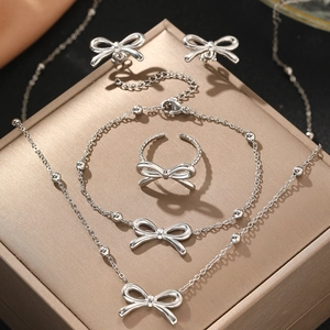 Polished 4-piece stainless steel bow jewelry set including necklace bracelet and ring