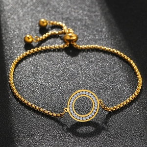 Detailed macro view of a gold hollow round charm bracelet with pave-set zircon crystals