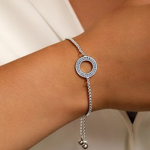 Detail of adjustable box chain bracelet with blue zircon hollow circular charm on wrist
