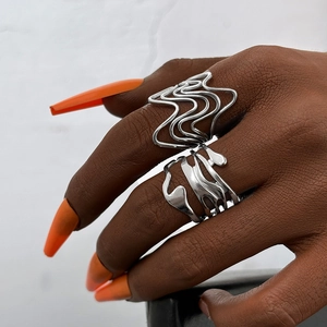 Macro detail of silver liquid lava rings with irregular wavy design on model hand