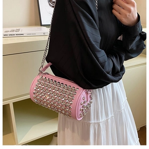 Detailed close-up of pink cylinder bag showing dense sparkling rhinestone texture and chain