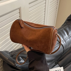 Minimalist brown suede Boston cylinder crossbody bag with top zipper closure