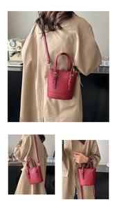 Détails du sac seau rouge en cuir grainé avec styles porté main et bandoulière élégants