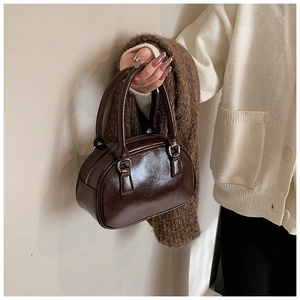 Detail of glossy coffee brown leather texture and zipper on this vintage Boston bag