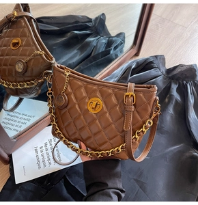 Detail of brown quilted faux leather hobo bag with gold chain and twist lock closure