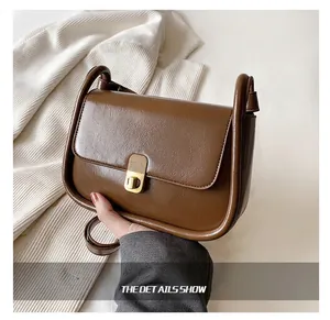 Close-up of retro dark brown crossbody bag featuring premium lychee pattern texture