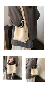 Detailed side and back view of a beige pebble leather bucket bag styled with an outfit
