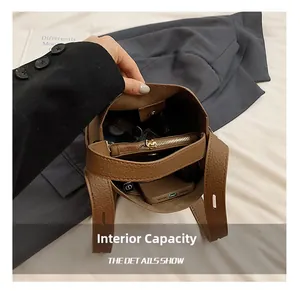 Detailed internal view of brown leather bucket bag showing large capacity for essentials