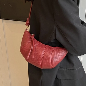 Retro burgundy lychee grain leather croissant bag for women shown on a model shoulder