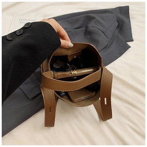 Internal view of the brown pebble leather bucket bag showing large capacity and inner pocket
