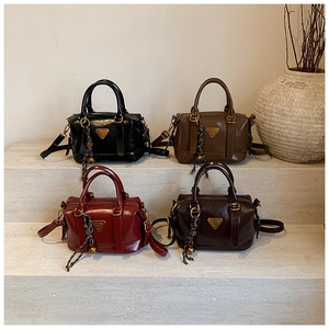 Detail of vintage Boston handbags in four colors featuring triangular metal logos