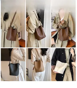 Trois sacs seau en cuir minimalistes en marron, noir et crème avec détails de couture