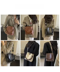 Detailed views of vintage bucket bag with patterned wide strap and decorative chain link