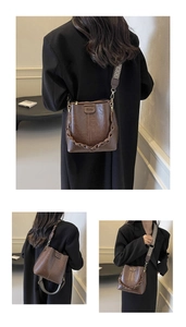 Detail of vintage brown bucket bag with bohemian geometric wide strap and leather texture