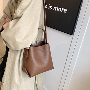 Brown litchi pattern leather bucket bag with top handle and shoulder strap for women