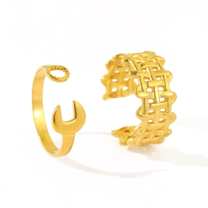 Minimalist gold adjustable wrench and woven textured rings set on a white background
