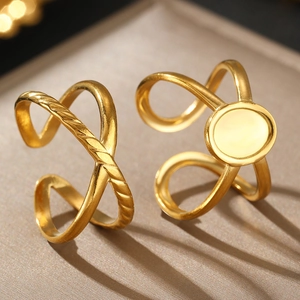 Macro detail of 18K gold plated stainless steel rings featuring twisted crossover designs