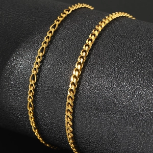 Detail shot of golden stainless steel double-layer anklet chain texture on a black stand