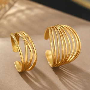 Minimalist multi-layer gold plated open rings with hollow linear design on beige background