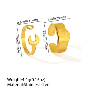 Detail of gold stainless steel wrench ring and irregular hammered wide band set