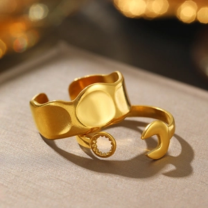 Close-up of gold irregular hammered band and sun-moon ring on velvet display
