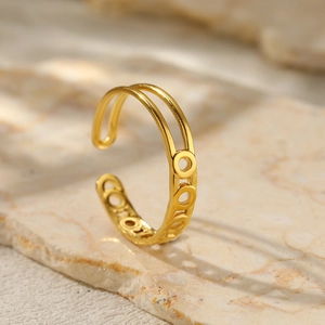 Macro shot of 18K gold plated wide geometric ring with asymmetric open design on stone