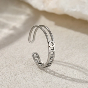Close-up of geometric open silver ring with double-layered hollow circle design