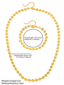 Detail of gold stainless steel necklace and bracelet set with sunray sunburst coin charms
