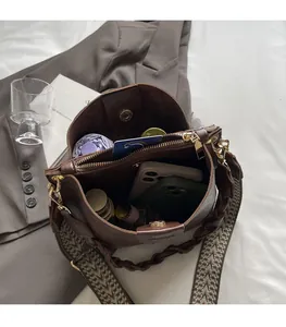 Spacious interior of dark brown leather bucket bag showing storage for umbrella and phone