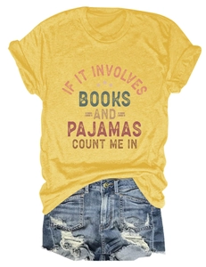 Detail of a ginger yellow t-shirt with book slogan and distressed denim shorts