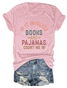 Flat lay of a pink t-shirt with book slogan and distressed denim shorts outfit